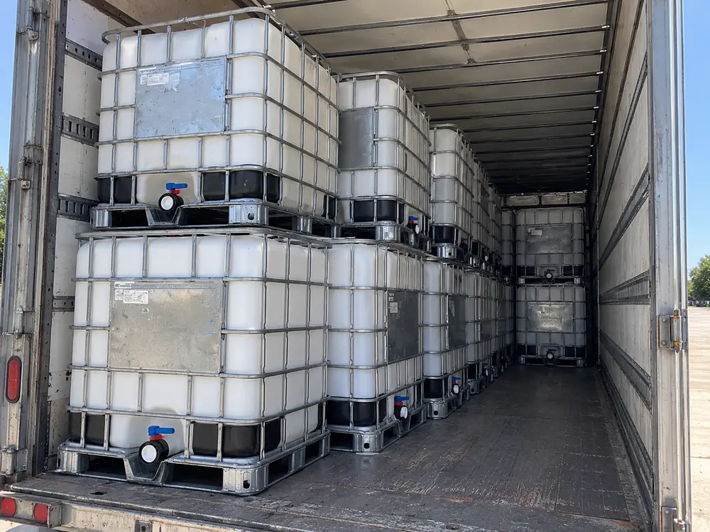 IBC totes loaded two tiers deep inside a trailer